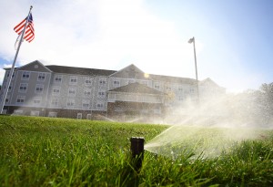 active sprinkler system in front of commercial building