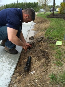 irrigation technician replacing broken sprinkler head