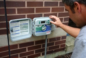 man operating irrigation controller