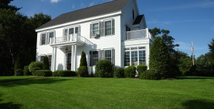 white house with mowed lawn