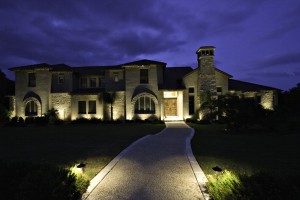 landscape lighting illuminating house and walkway