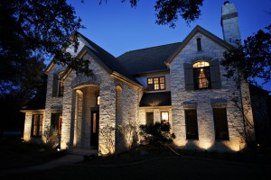 landscape lighting illuminating stone house