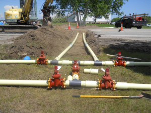 water utility lines being dug underneath a road