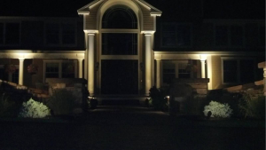 house lighted by landscape lights