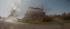 thirsty turf sprinklers outside suburban house