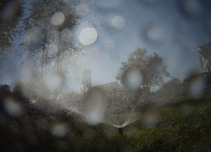 sprinkler close up with water on the lens