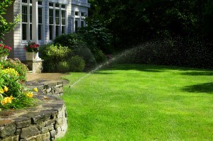 sprinkler watering lawn outside patio