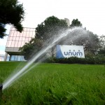 unum sign with grass and irrigation