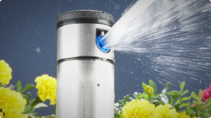 Sprinkler head with metallic finish watering flowers