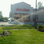irrigation system watering the lawn outside AutoZone