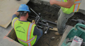 thirsty turf irrigation technician working on irrigation piping