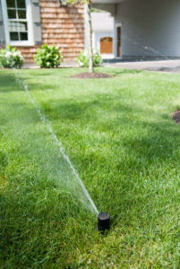 sprinkler system watering green lawn